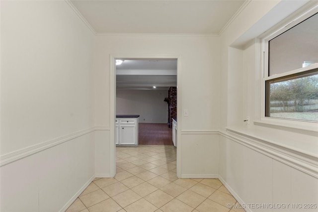 hall with crown molding and light tile patterned floors