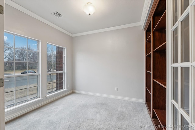 unfurnished room featuring ornamental molding, carpet, and a healthy amount of sunlight