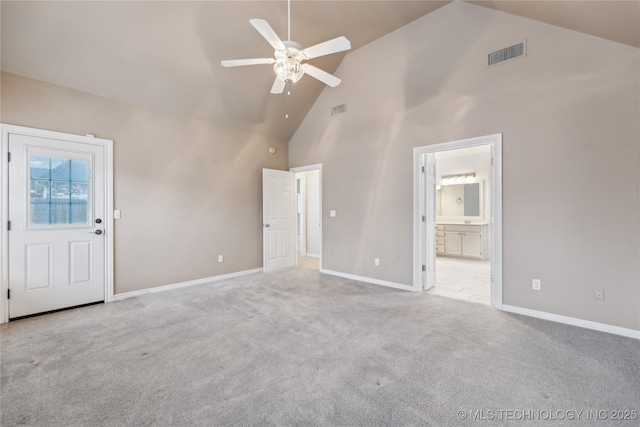 unfurnished living room featuring ceiling fan, light colored carpet, and high vaulted ceiling