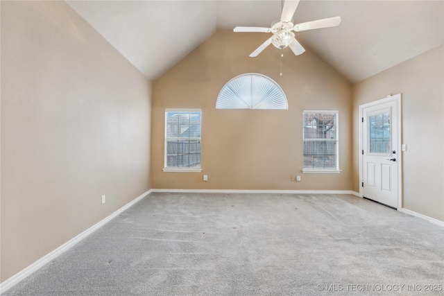 spare room featuring lofted ceiling, light colored carpet, and ceiling fan