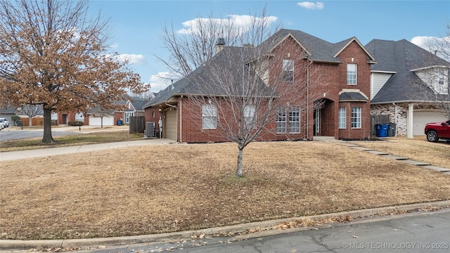 front of property featuring central AC and a front yard