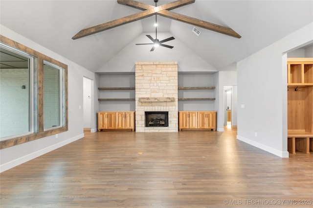 unfurnished living room with ceiling fan, high vaulted ceiling, a fireplace, and hardwood / wood-style floors