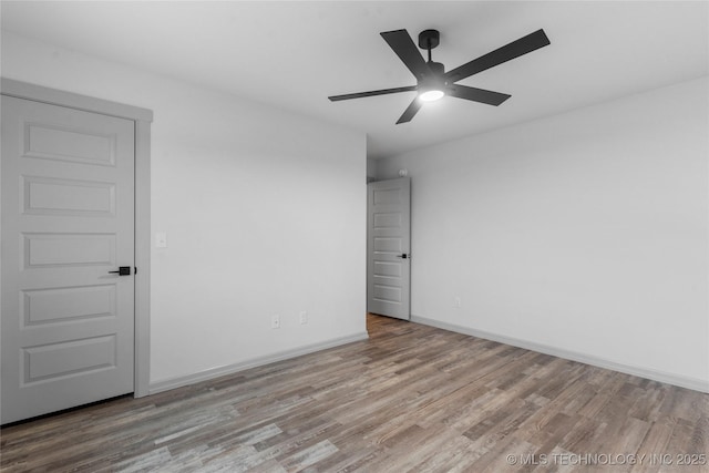 empty room featuring ceiling fan and light hardwood / wood-style floors