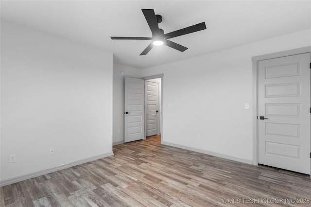 spare room featuring ceiling fan and light hardwood / wood-style floors