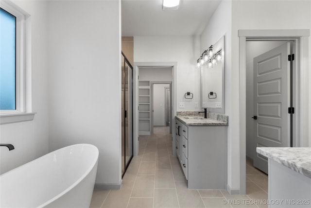 bathroom with vanity, tile patterned floors, and plus walk in shower