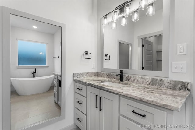 bathroom featuring vanity, a tub, and tile patterned floors