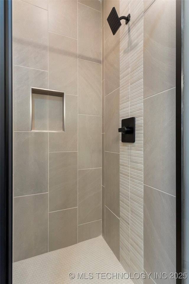 bathroom with a tile shower