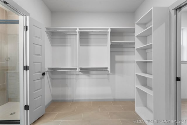 walk in closet featuring light tile patterned floors