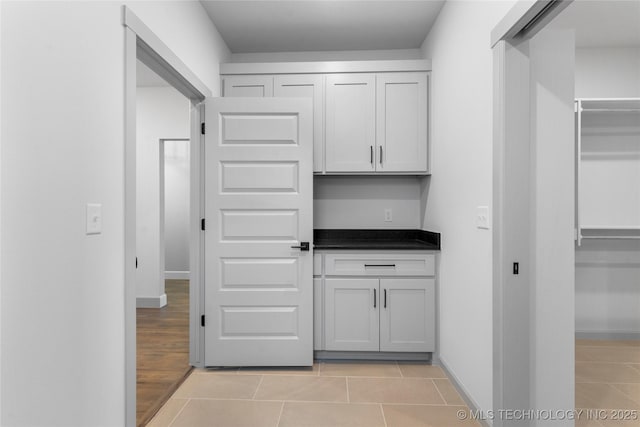 kitchen with white cabinetry and light tile patterned floors