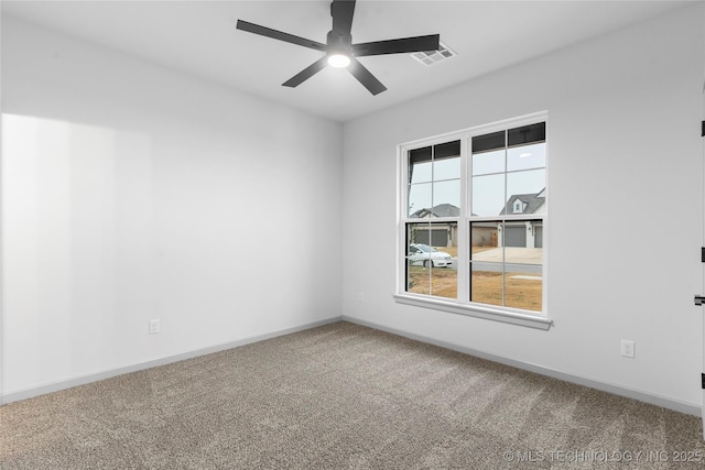 spare room featuring ceiling fan and carpet flooring