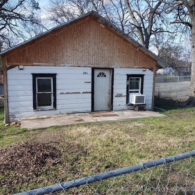 exterior space featuring cooling unit, a patio, and a front lawn