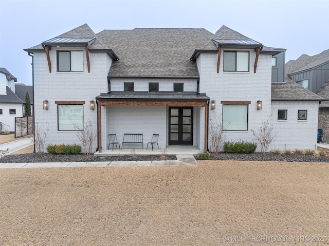 view of front of property with a porch and french doors