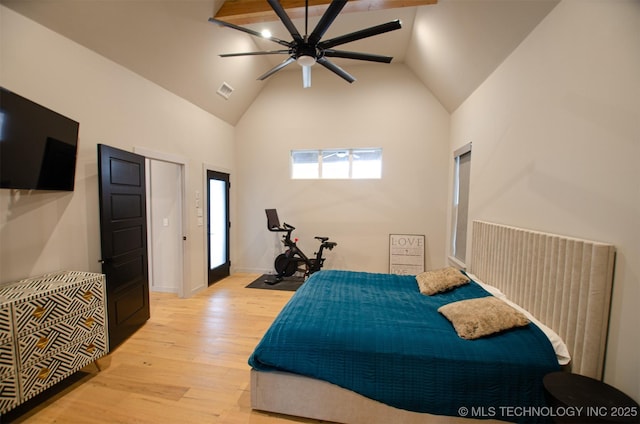 bedroom featuring ceiling fan, high vaulted ceiling, and light hardwood / wood-style flooring