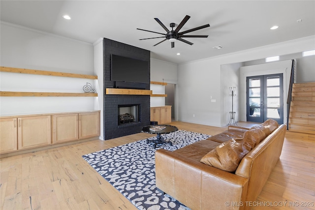 3748 E 116th St S, Tulsa, OK 74137 - living room featuring crown molding, a ceiling fan, light wood-style floors, a brick fireplace, and recessed lighting