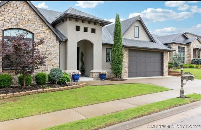 view of front facade with a garage and a front lawn