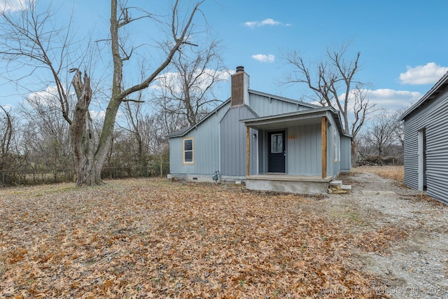 view of side of home with a porch