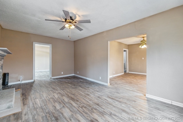 unfurnished living room featuring hardwood / wood-style flooring, a textured ceiling, and ceiling fan