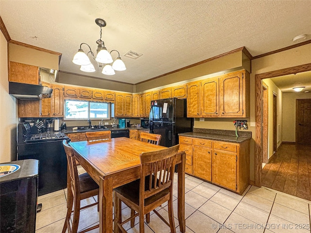 kitchen with crown molding, sink, light tile patterned floors, and black appliances