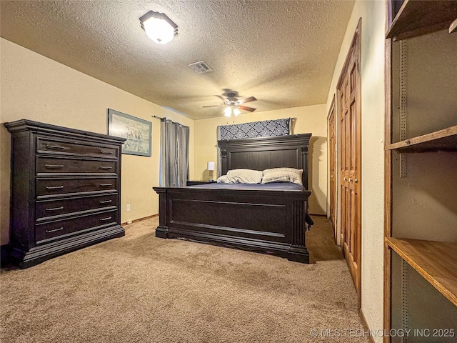 bedroom featuring ceiling fan, a textured ceiling, and carpet flooring