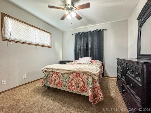 bedroom featuring ceiling fan and dark carpet