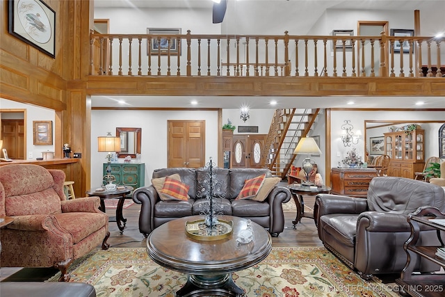 living room with a towering ceiling and light wood-type flooring