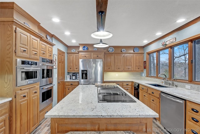 kitchen with stainless steel appliances, a center island, sink, and decorative light fixtures