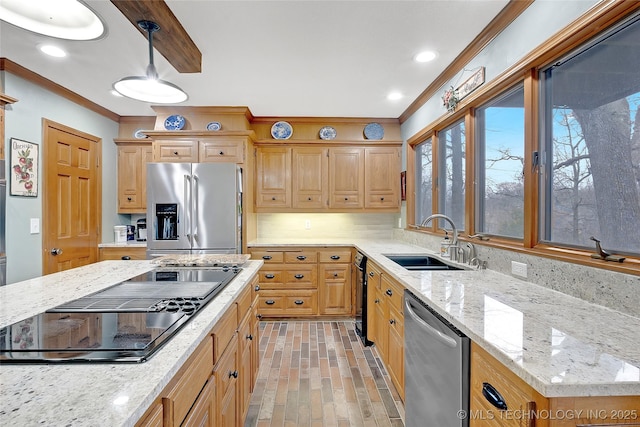 kitchen with sink, crown molding, light stone counters, decorative light fixtures, and appliances with stainless steel finishes