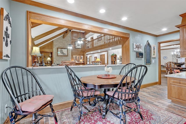 dining room with ornamental molding, vaulted ceiling with beams, ceiling fan, and light hardwood / wood-style floors