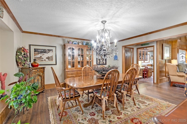 dining room with crown molding, dark hardwood / wood-style floors, and a textured ceiling