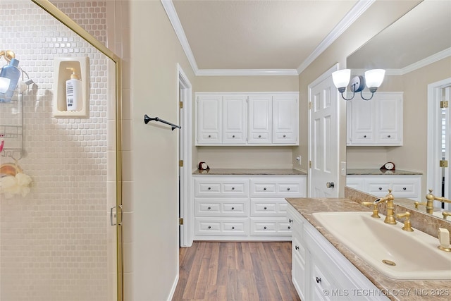 bathroom with walk in shower, crown molding, an inviting chandelier, wood-type flooring, and vanity