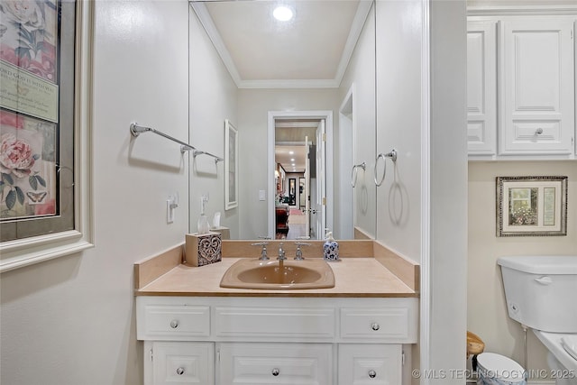 bathroom with vanity, crown molding, and toilet