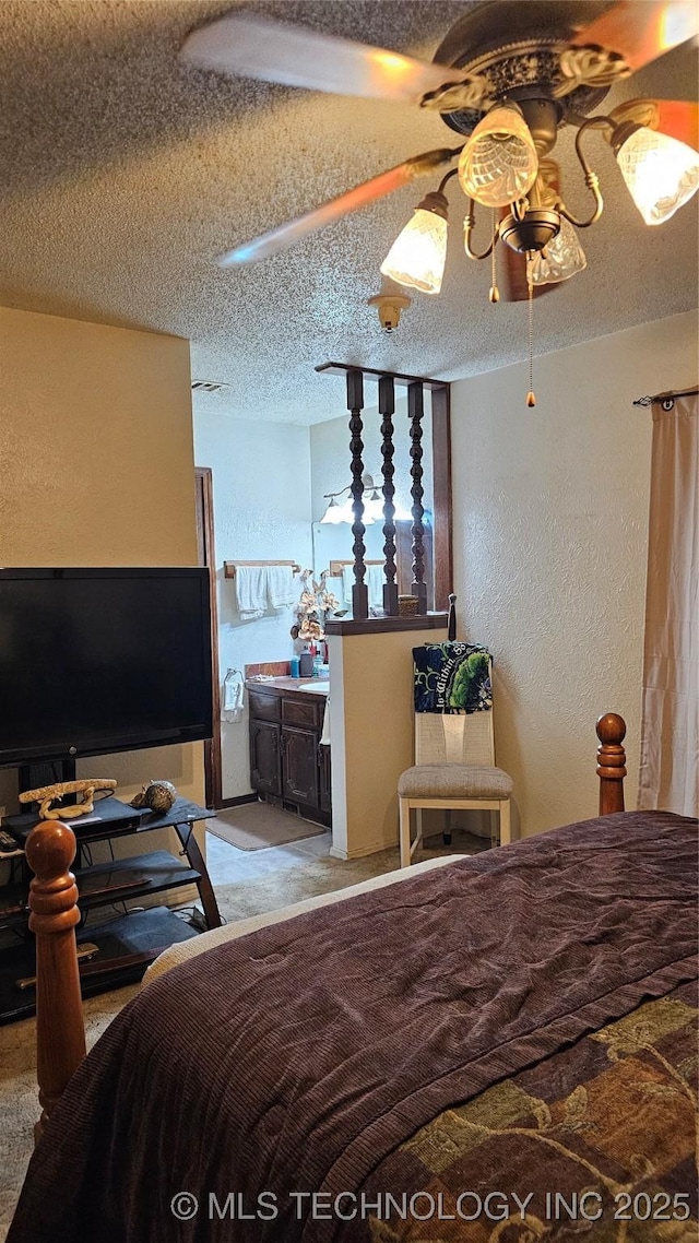 carpeted bedroom with ceiling fan and a textured ceiling