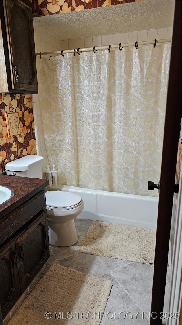 full bathroom featuring shower / bathtub combination with curtain, vanity, toilet, and a textured ceiling