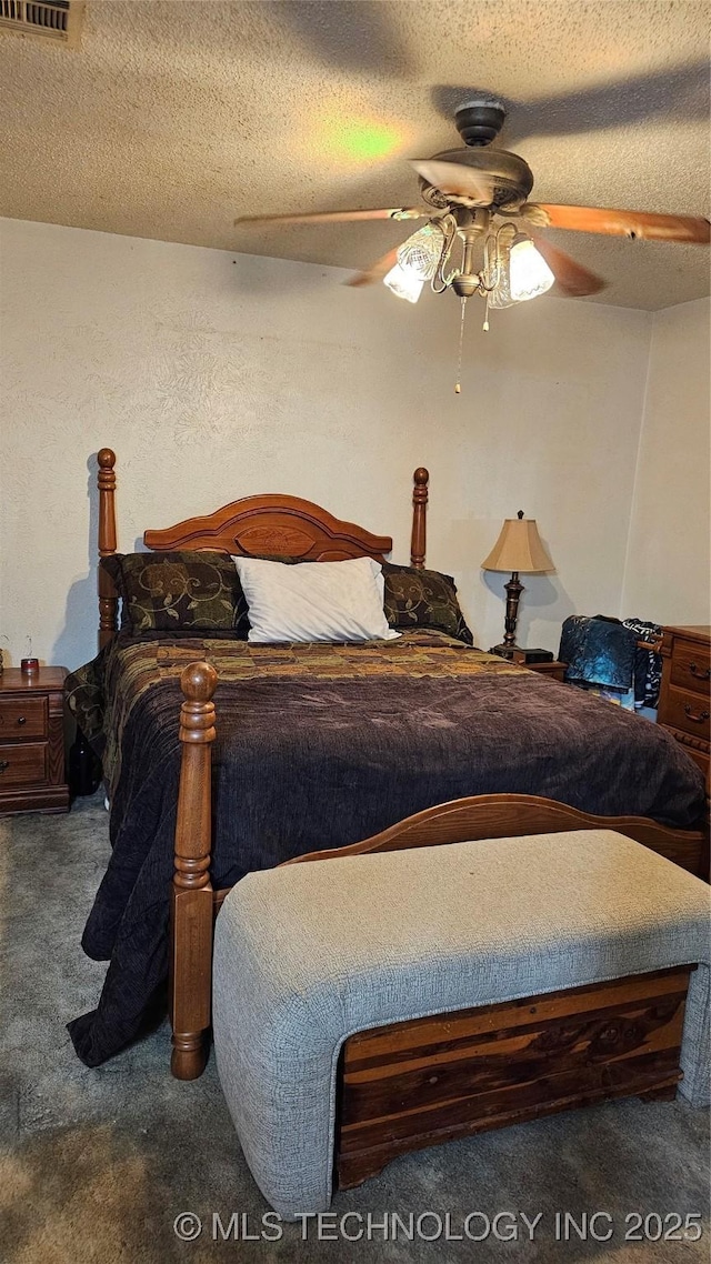 carpeted bedroom with ceiling fan and a textured ceiling