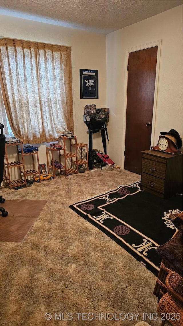 carpeted bedroom featuring a textured ceiling