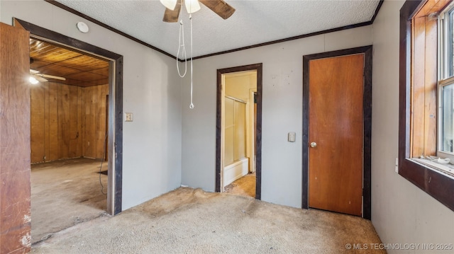 bedroom featuring crown molding, ensuite bath, and a textured ceiling