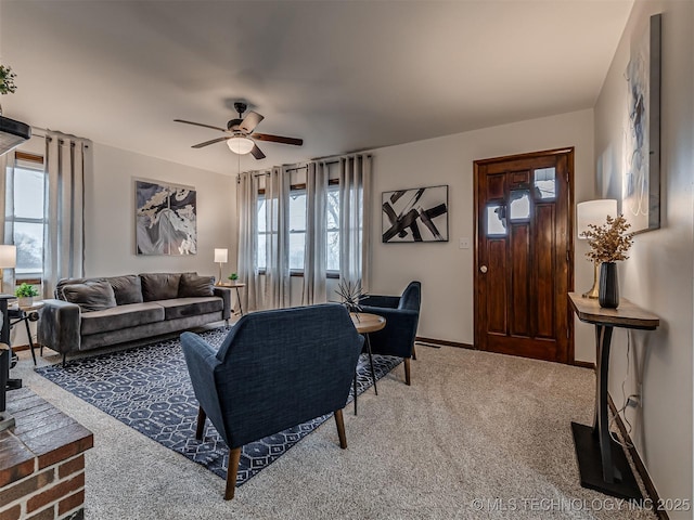 living room with ceiling fan and carpet