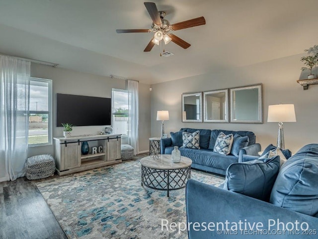 living room featuring wood-type flooring and ceiling fan