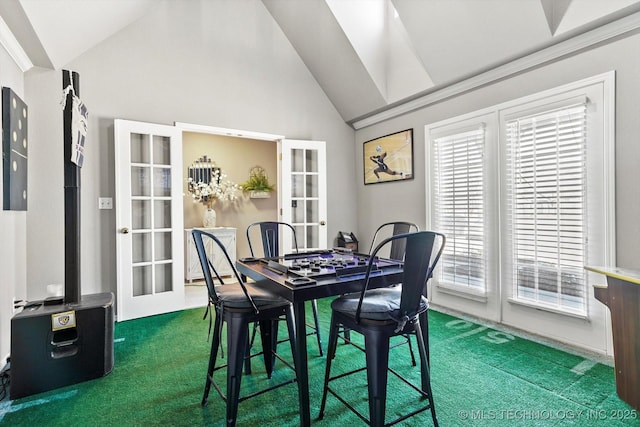 dining room with carpet floors, french doors, and vaulted ceiling