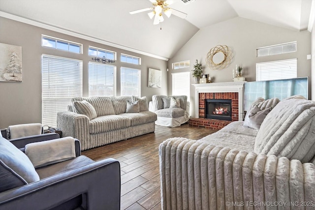 living room featuring ceiling fan, dark hardwood / wood-style floors, high vaulted ceiling, and a brick fireplace