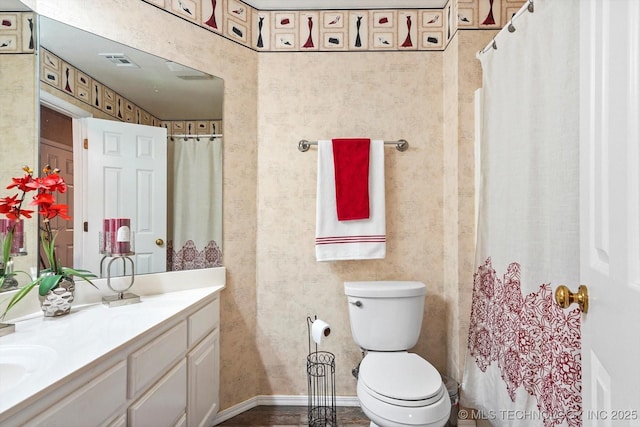 bathroom featuring curtained shower, vanity, toilet, and visible vents