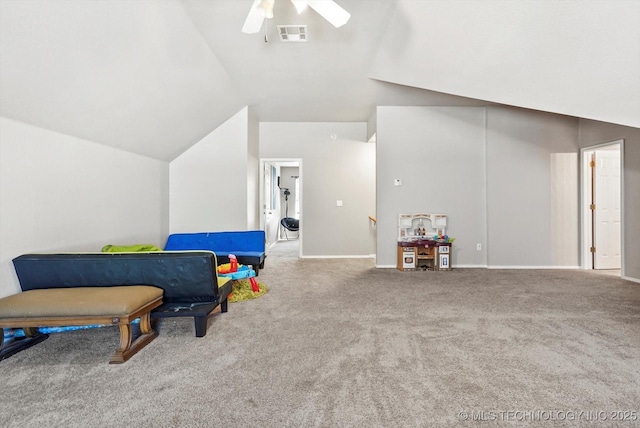 rec room with vaulted ceiling, light colored carpet, and ceiling fan