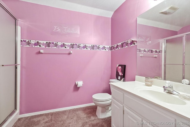 bathroom featuring vanity, a shower with door, and toilet