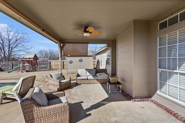 view of patio / terrace featuring ceiling fan, an outdoor living space, and a playground