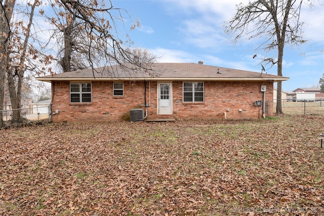 back of house with central AC unit