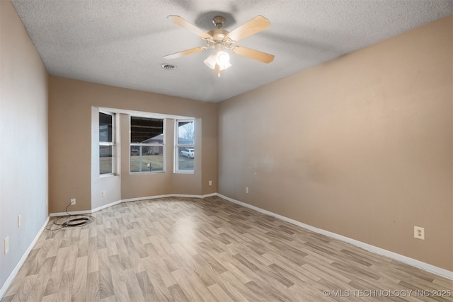 unfurnished room featuring a textured ceiling, ceiling fan, and light hardwood / wood-style flooring