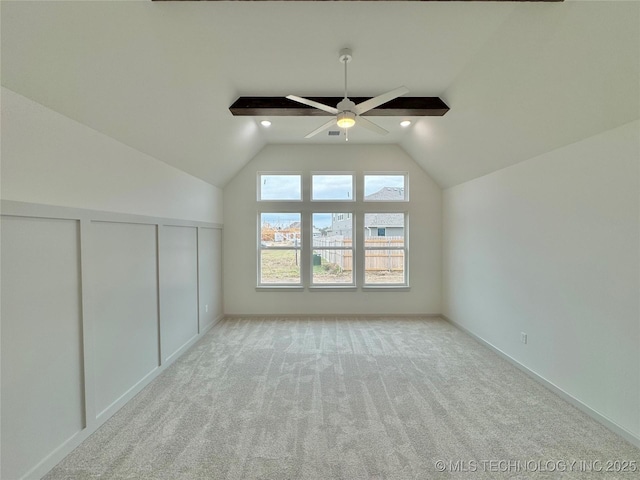 additional living space featuring vaulted ceiling, light carpet, and ceiling fan