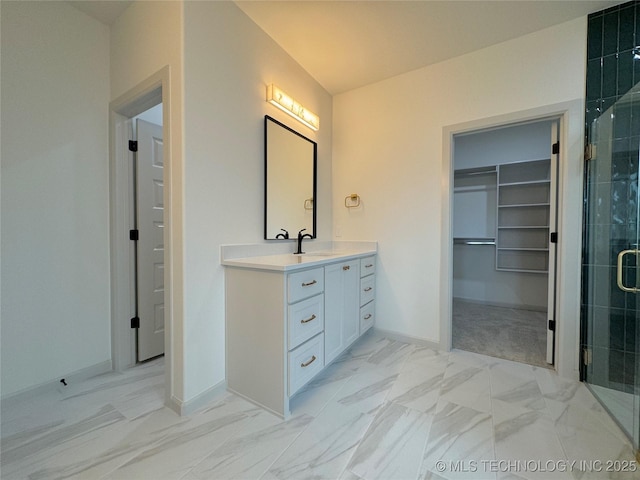 bathroom featuring vanity and a shower with shower door