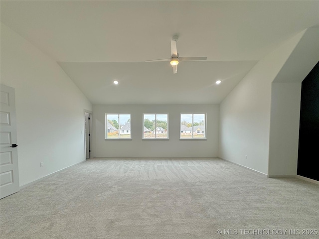 carpeted spare room with high vaulted ceiling and ceiling fan