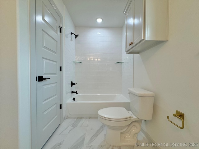 bathroom featuring tiled shower / bath and toilet